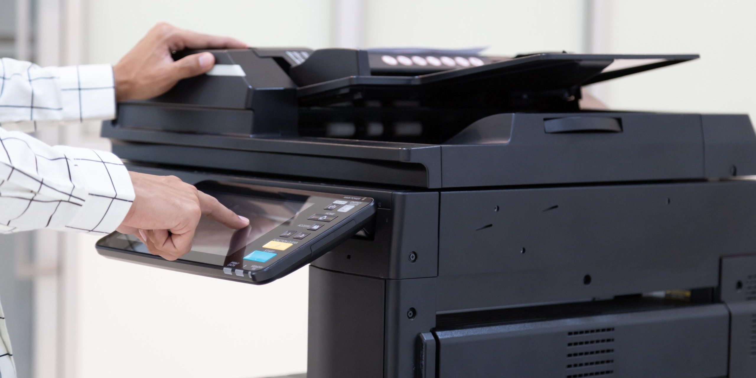 Bussinessman press button on panel of printer photocopier