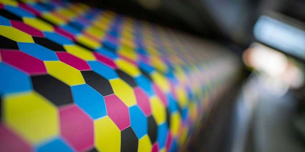digital vs offset printing Close-up of a CMYK honeycomb pattern on a printer roller for digital vs offset printing.