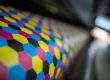 Close-up of a CMYK honeycomb pattern on a printer roller for digital vs offset printing.